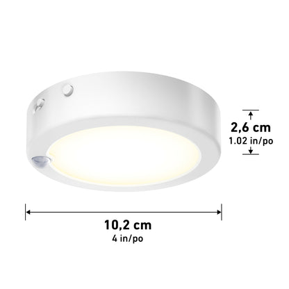 The Artika Accent under cabinet LED light 3CCT is a round, white puck light with a 10.2 cm (4 in) diameter, 2.6 cm (1.02 in) height, and features a visible motion sensor on the side.