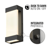 A modern rectangular outdoor wall light with a glowing panel. Text reads “Dusk to Dawn Auto On/Off” and “Integrated Photocell,” with a close-up showing the photocell sensor on the fixture.