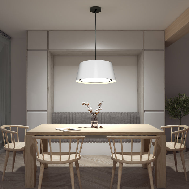 A modern dining area with a wooden table, four matching chairs, a gray-upholstered bench, the Artika Cappa LED pendant light 3 CCT as the centerpiece, and a minimalist vase with branches on the table.