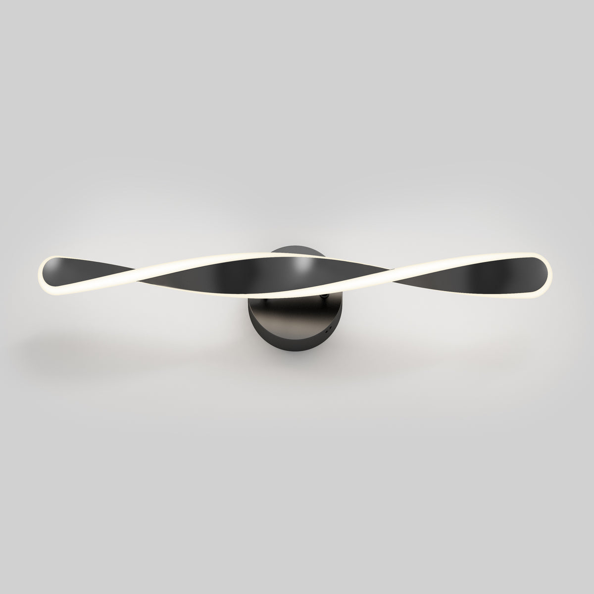 A modern wall-mounted LED light fixture with two intertwined, curved black and white bars, emitting a soft glow, set against a plain gray background.