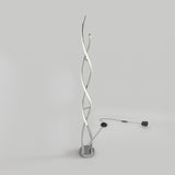 A modern floor lamp with two intertwined, spiral LED light strips on a circular base, plugged into a power outlet, set against a plain light grey background.