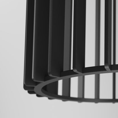 Close-up of the Artika Gatsby Mini modern mid-century pendant light, featuring a black metal shade with vertical slats and a circular base, set against a plain light background.