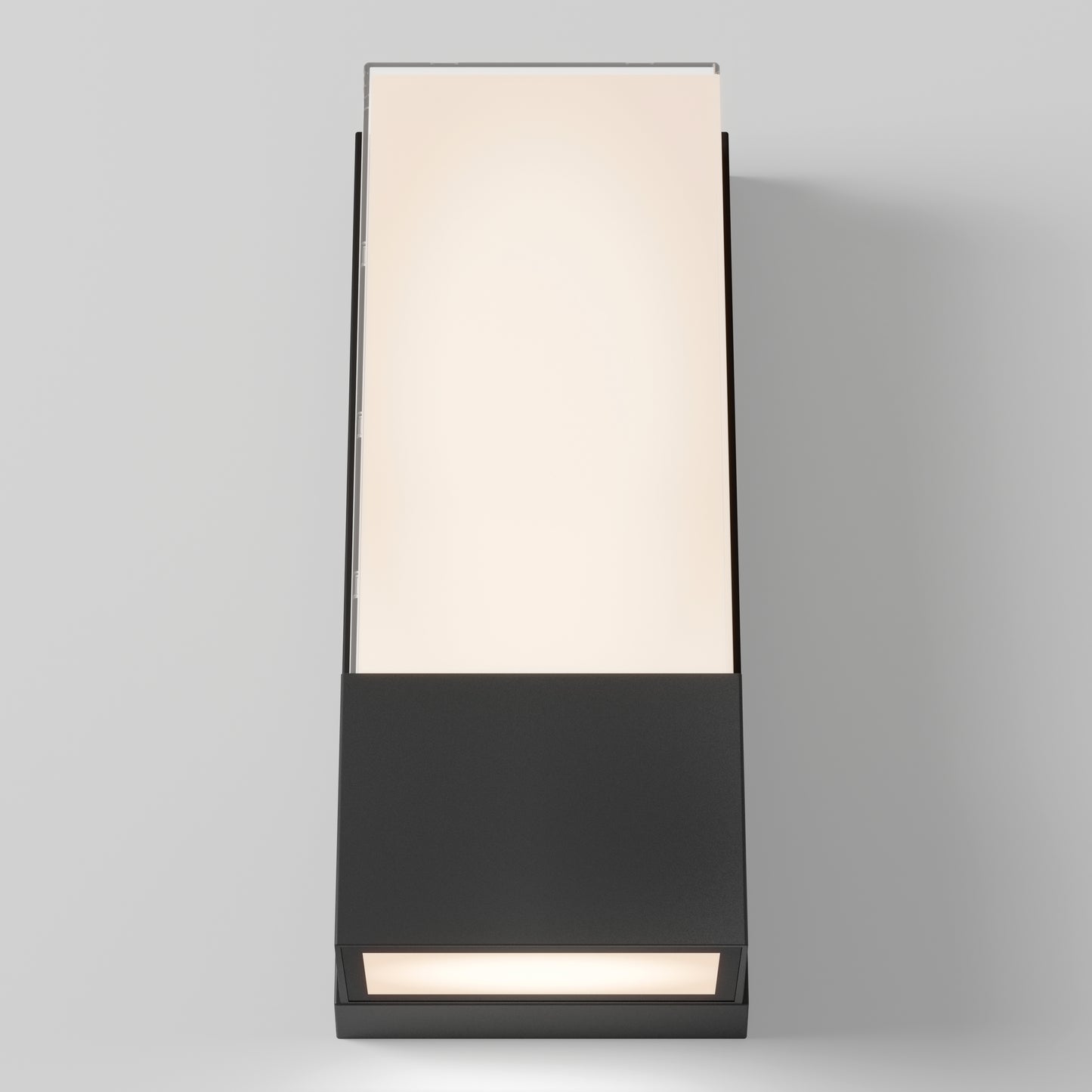 The Artika Dixon indoor-outdoor LED wall light features a rectangular design with a frosted top panel, matte black base, and emits a soft warm glow—perfectly mounted on a light gray wall.