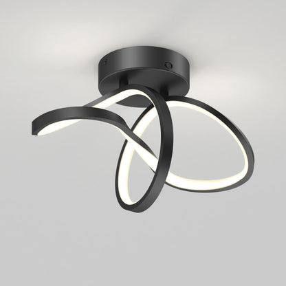 The Artika Loop modern LED flush mount light 3 CCT features two intertwined black curved LED strips on a round black base, casting a soft white glow against a light gray ceiling.