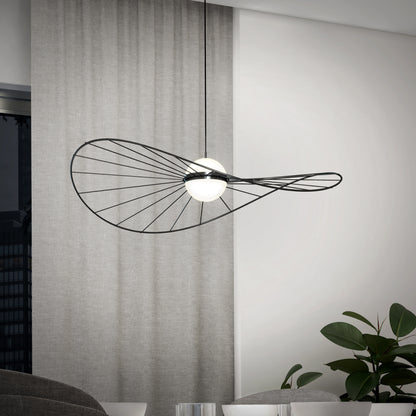 The Artika Tolena LED pendant light 3 CCT, featuring a sculptural black wire frame and two white globes, hangs in a minimalist room with light gray curtains, a window, and a green indoor plant.