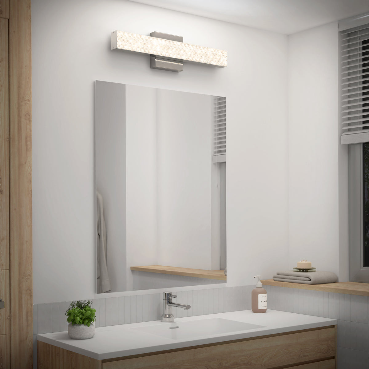 Modern bathroom with a large mirror, minimalist sink, plant, and Artika Adeline LED vanity light with adjustable 3 CCT.