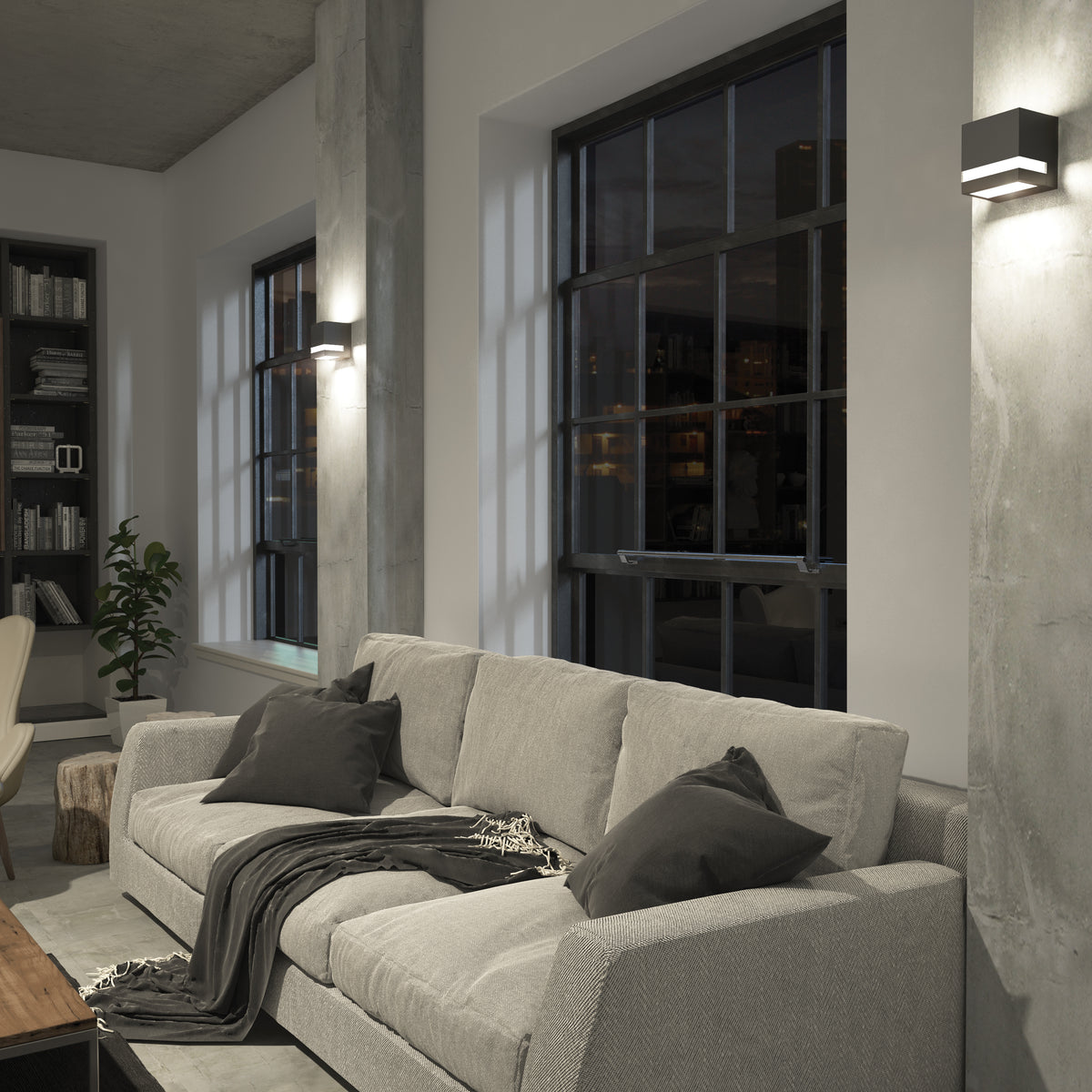 Modern living room with gray sofa, dark pillows, plant, bookshelves, and Artika Valor Square LED indoor-outdoor wall light.