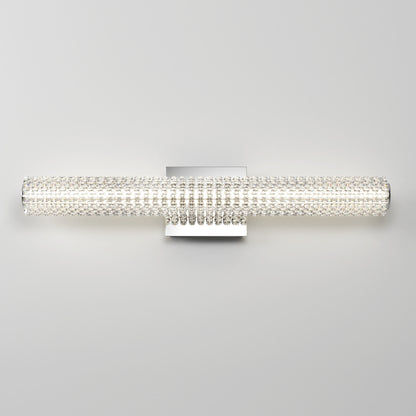 The Artika Exalto LED bathroom vanity light is a modern, wall-mounted fixture featuring a long, cylindrical design with a textured crystal-like surface that emits a bright, even glow.