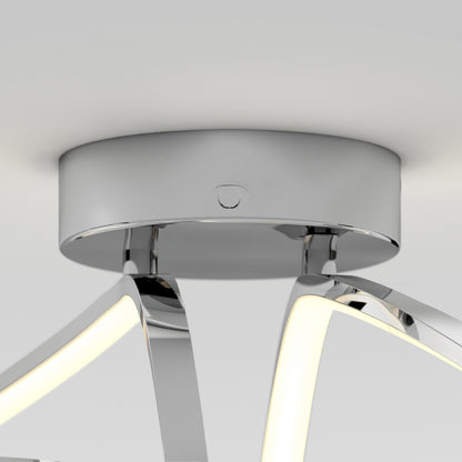 Close-up of a modern ceiling light fixture with a shiny chrome base and curved, illuminated LED arms extending outward, set against a plain white ceiling.