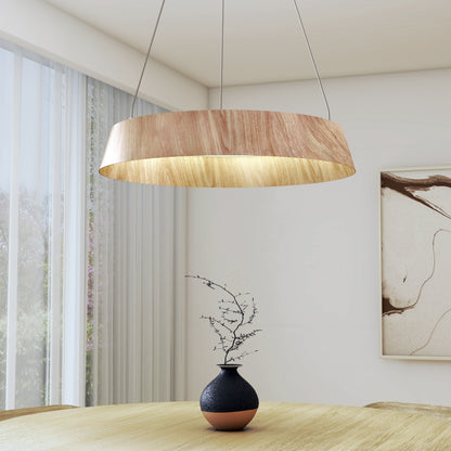 A modern dining area features the Artika Tallis LED pendant light 5 CCT hanging above a textured beige table with a decorative vase, set against abstract wall art and floor-to-ceiling windows.