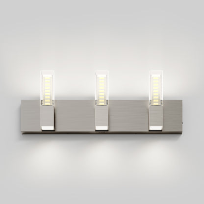 The Artika Hologram LED modern bathroom vanity light 5 CCT features three rectangular LED lights in clear covers on a brushed metal base, illuminating up and down on a white wall with a sleek, contemporary design.